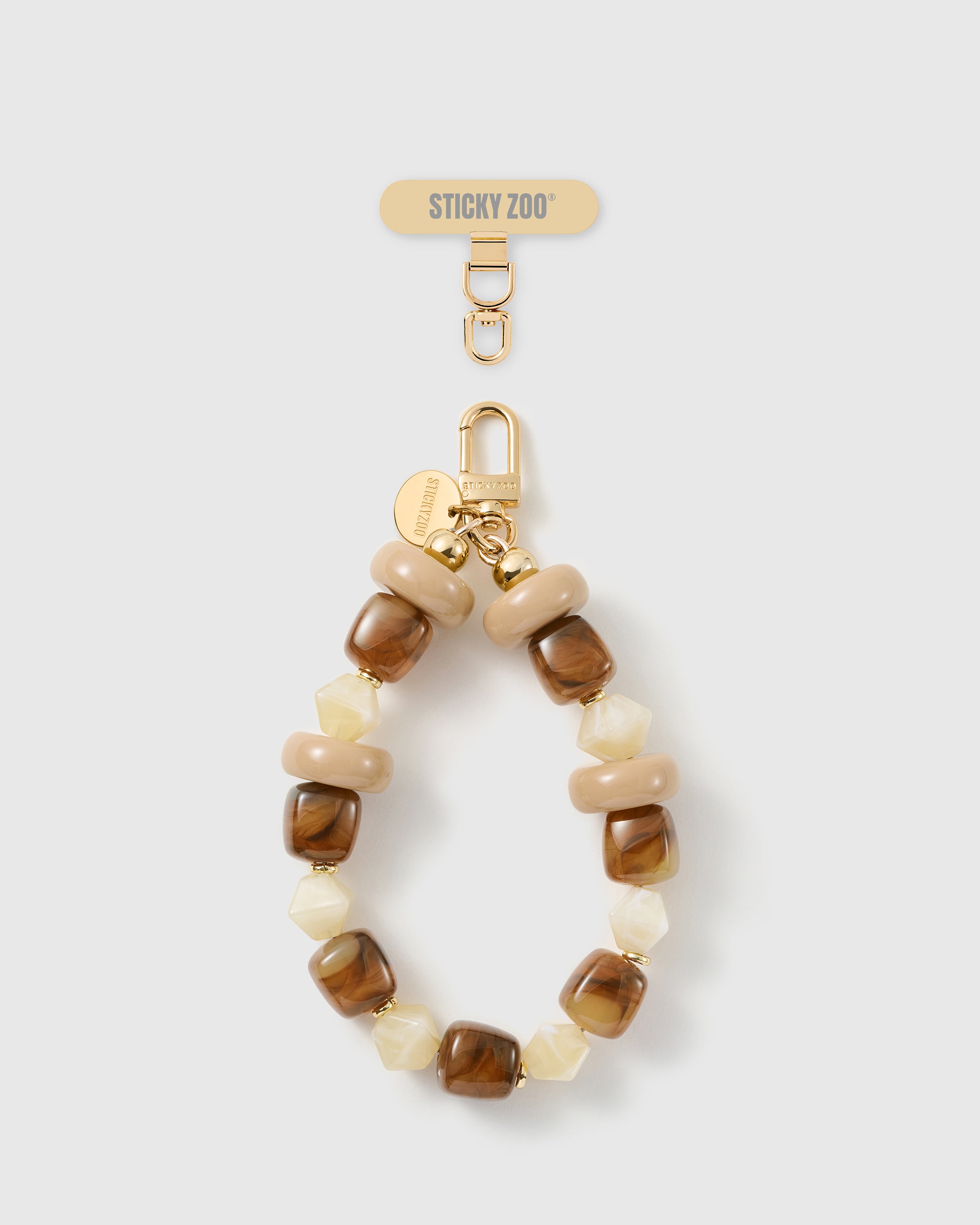 Handmade toffee marbled bead phone strap by STICKYZOO with 18K gold-plated engraved hardware