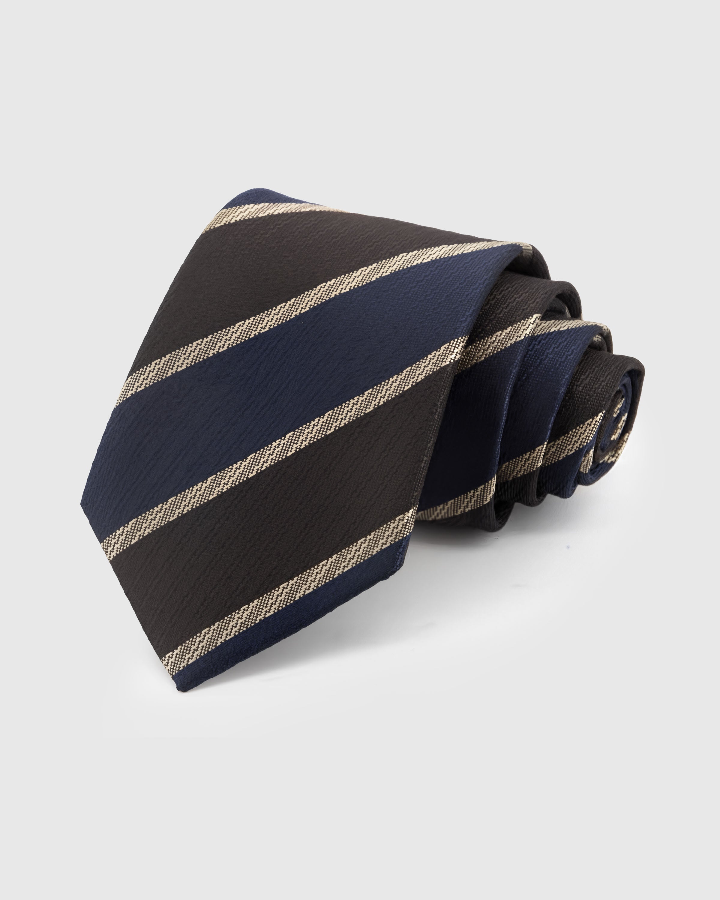ESPRESSO NAVY STRIPE TIE — Hand-embroidered regimental stripe detail on 100% mulberry silk in espresso, showing embroidery texture and silk sheen