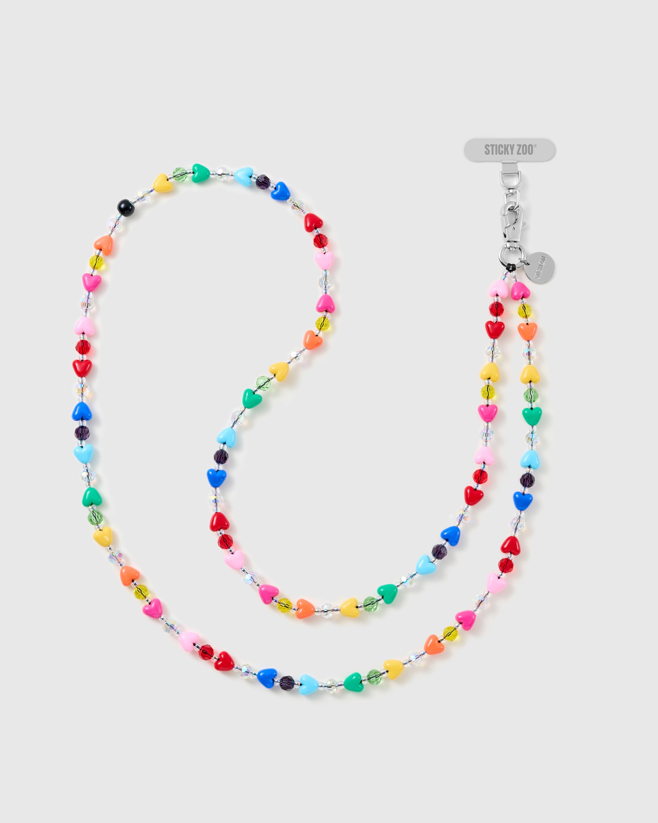 Full-length STICKYZOO cross-body phone strap in glossy multicolour heart beads with clear and coloured faceted spacers and a silver-tone clasp on white.