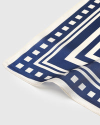 Close-up of the ivory checker-bar border meeting the navy chevron field on pure silk