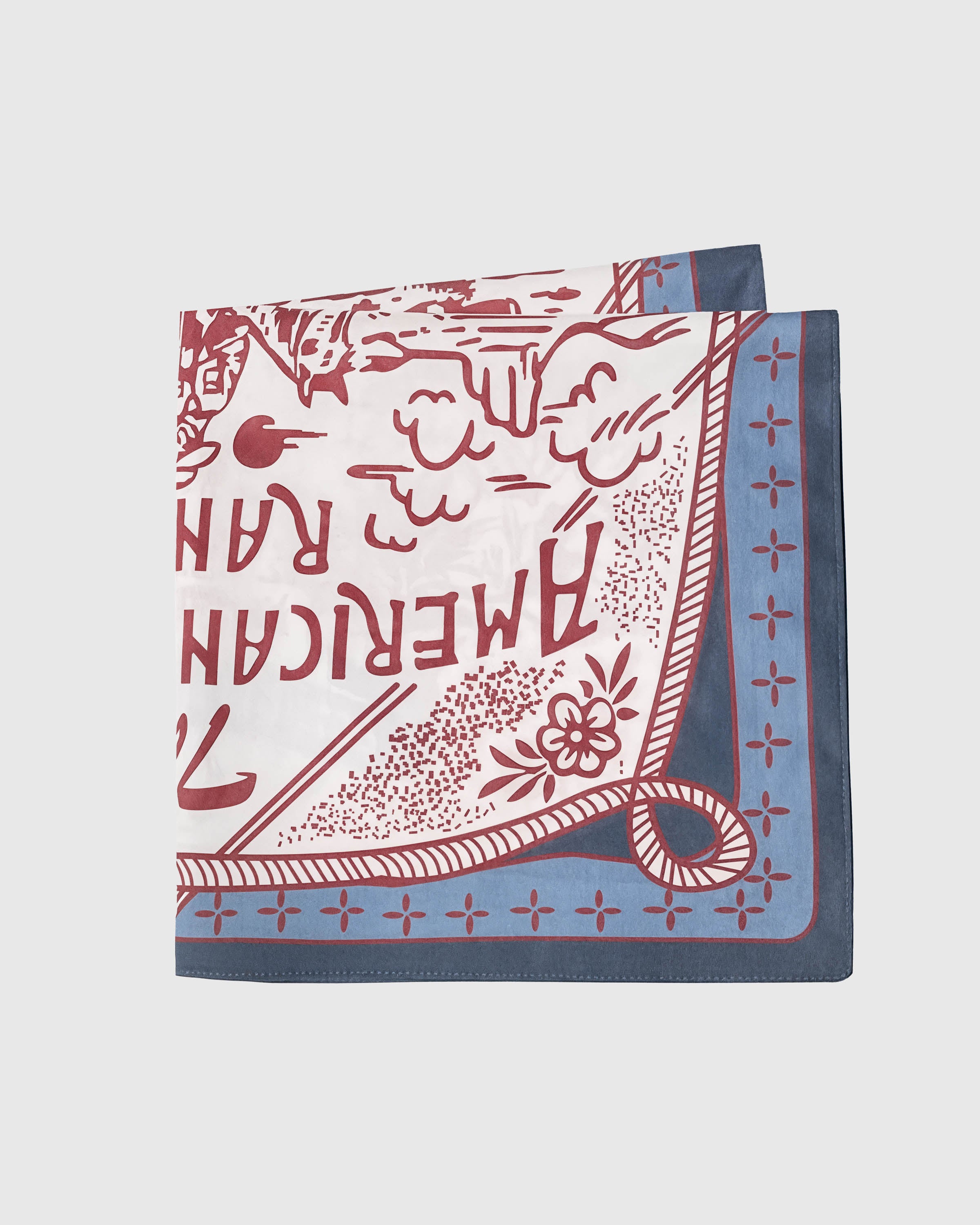 Folded western silk scarf showing the soft silk drape and the slate-blue rope frame