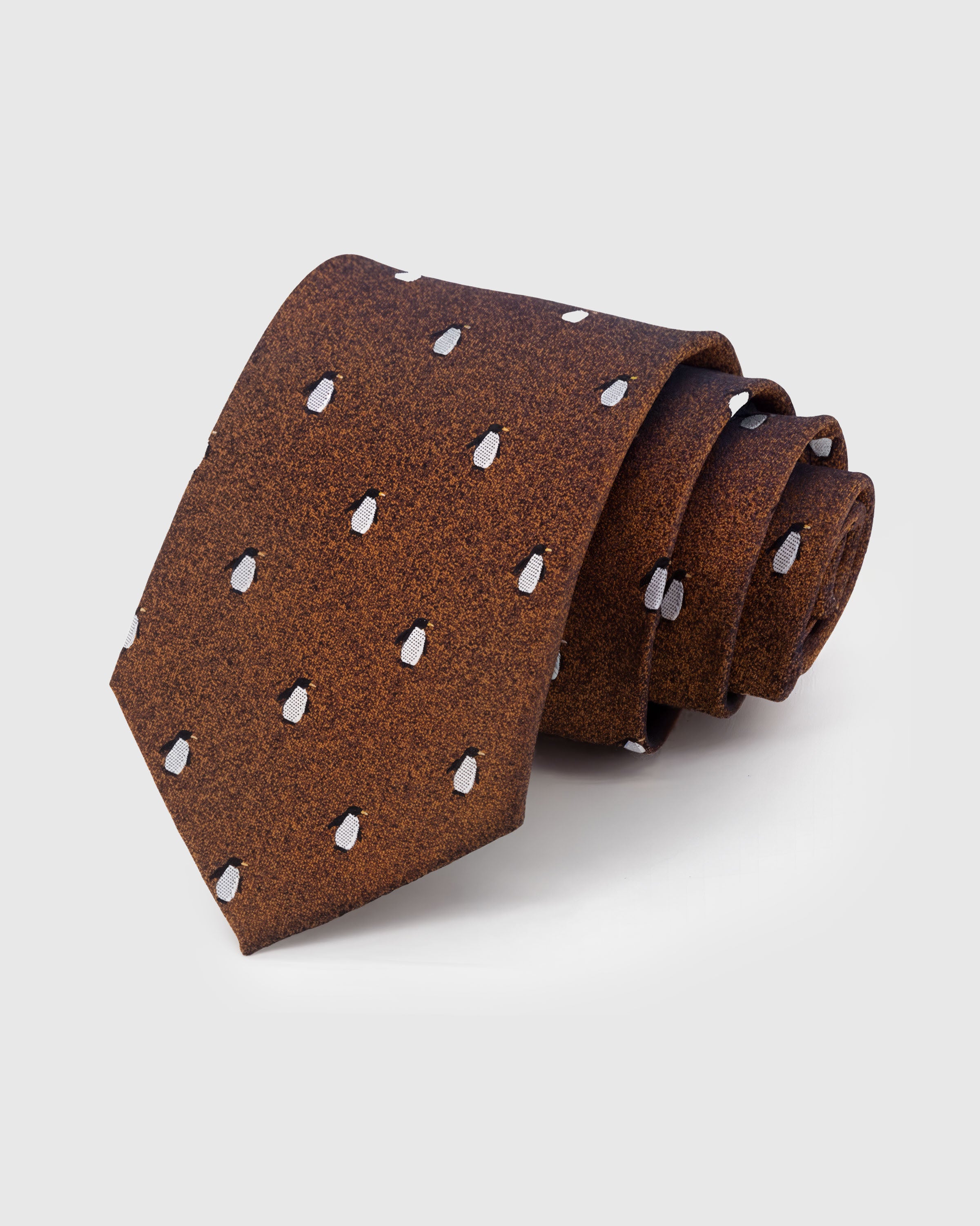 STICKYZOO Copper Penguin Tie in hand-embroidered mulberry silk with white penguin motifs on copper textured ground, 45° bias-cut Italian method