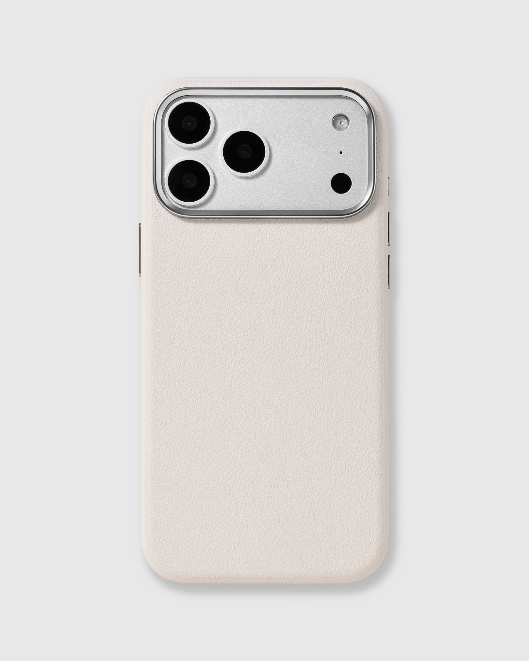 White fine-grain vegan leather iPhone case with a raised silver metal camera frame by STICKYZOO
