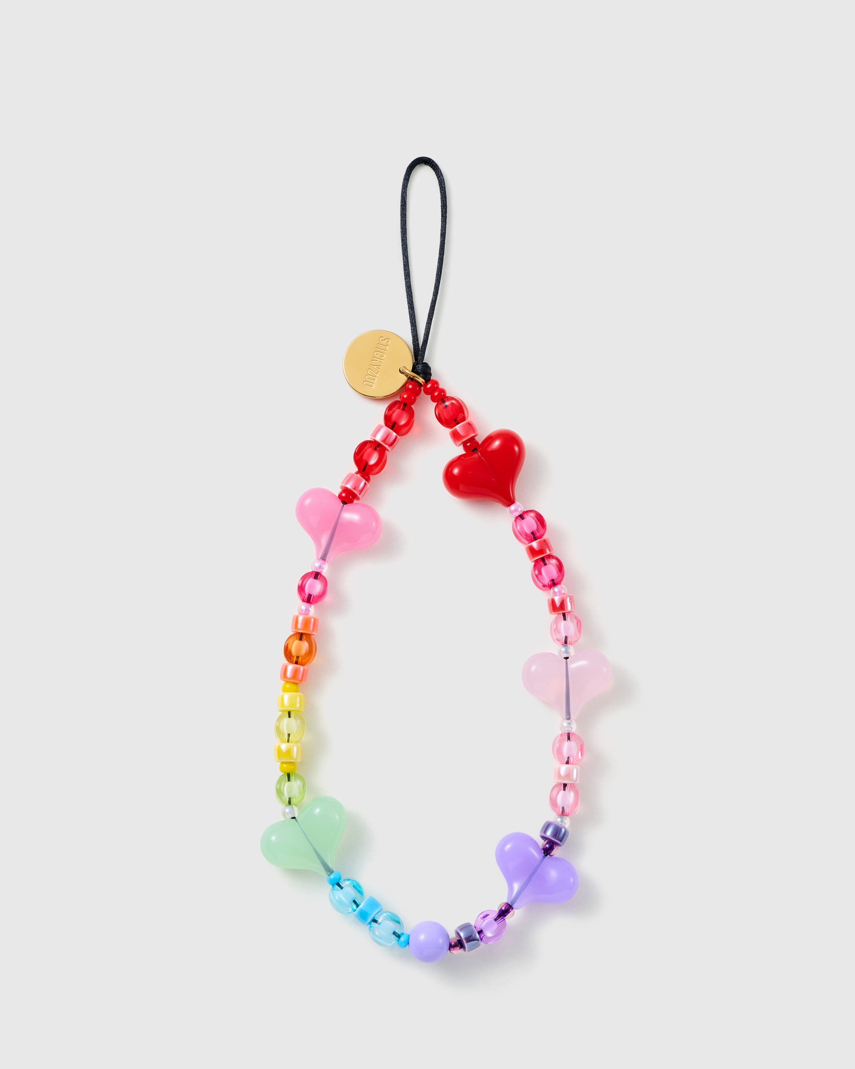 STICKYZOO Gummy Heart phone strap laid flat, a full loop of rainbow jelly heart beads with clear pony beads, black cord and gold disc.