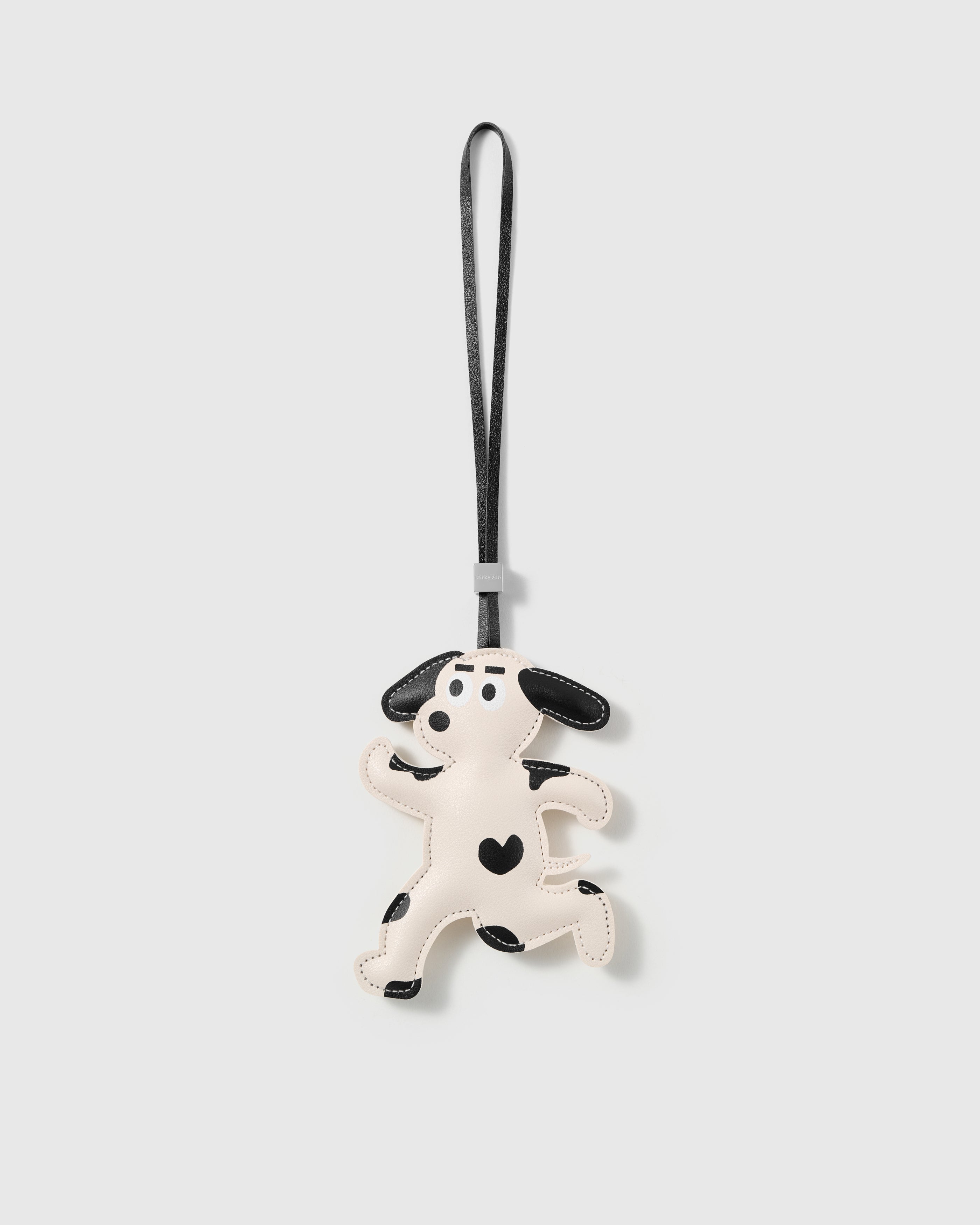 Handmade French Alran leather dalmatian bag charm with hand-cut spots and 18K gold-plated hardware by STICKYZOO