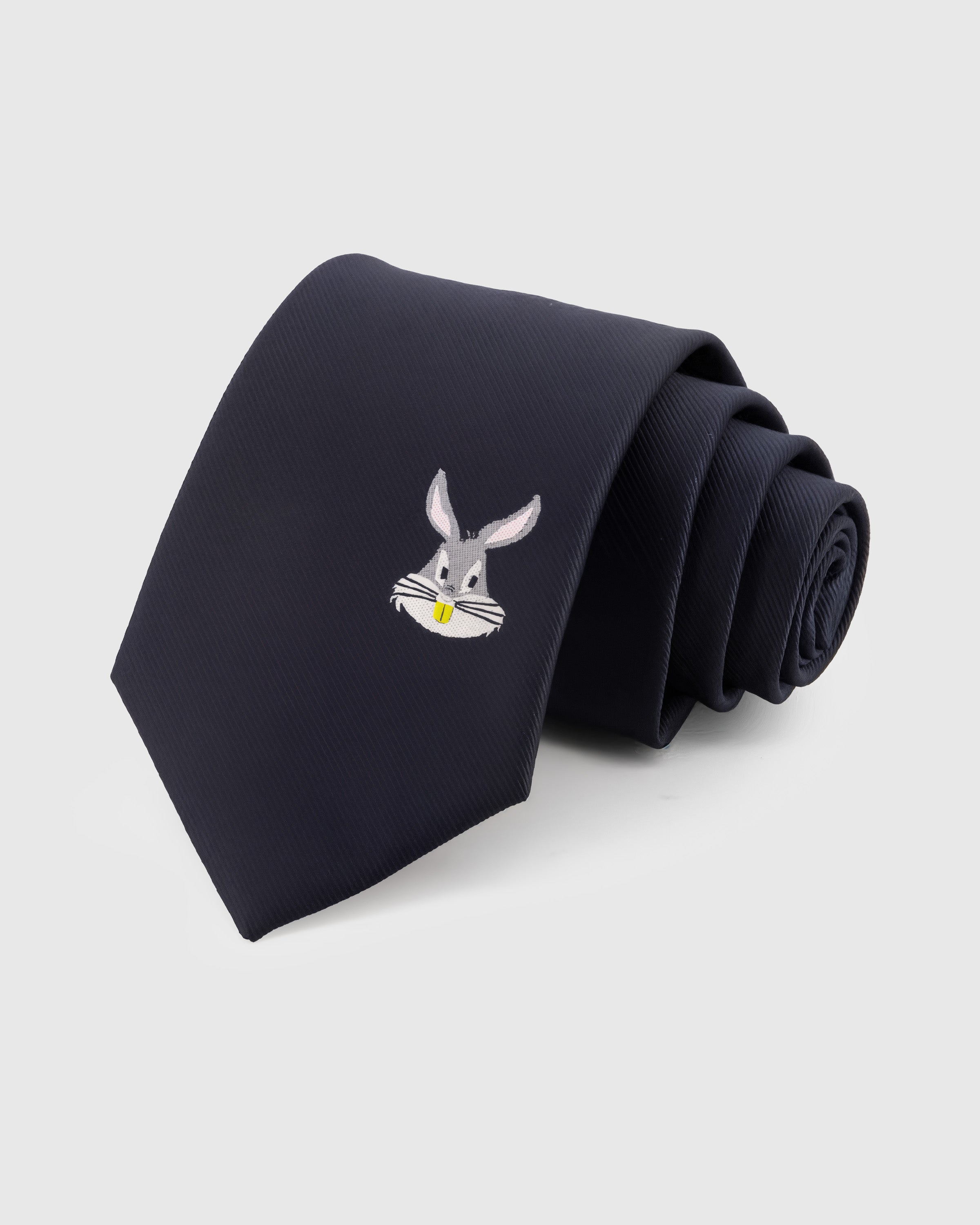 MIDNIGHT RABBIT TIE — Hand-embroidered rabbit detail on 100% mulberry silk in midnight navy, showing embroidery texture and silk sheen
