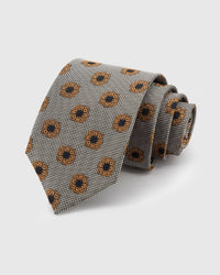STICKYZOO Pewter Rosette Tie in hand-embroidered mulberry silk with amber rosettes on pewter houndstooth ground, 45° bias-cut Italian method