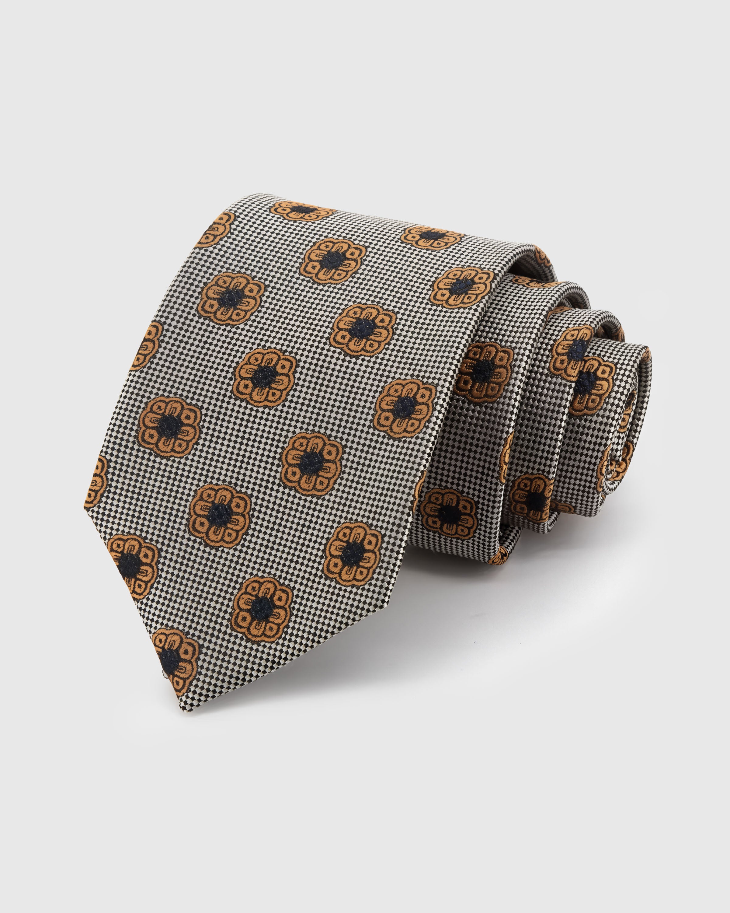 STICKYZOO Pewter Rosette Tie in hand-embroidered mulberry silk with amber rosettes on pewter houndstooth ground, 45° bias-cut Italian method