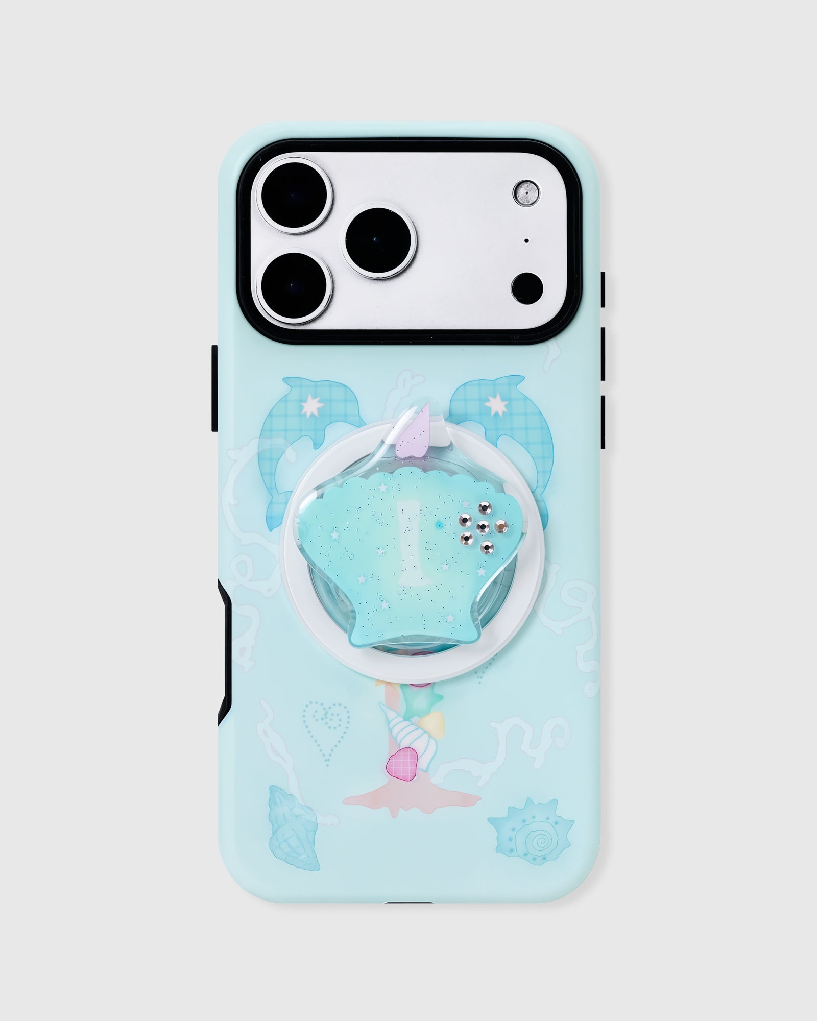 Mint dolphin cove phone case with hand-illustrated ocean print and a built-in MagSafe seashell grip by STICKYZOO