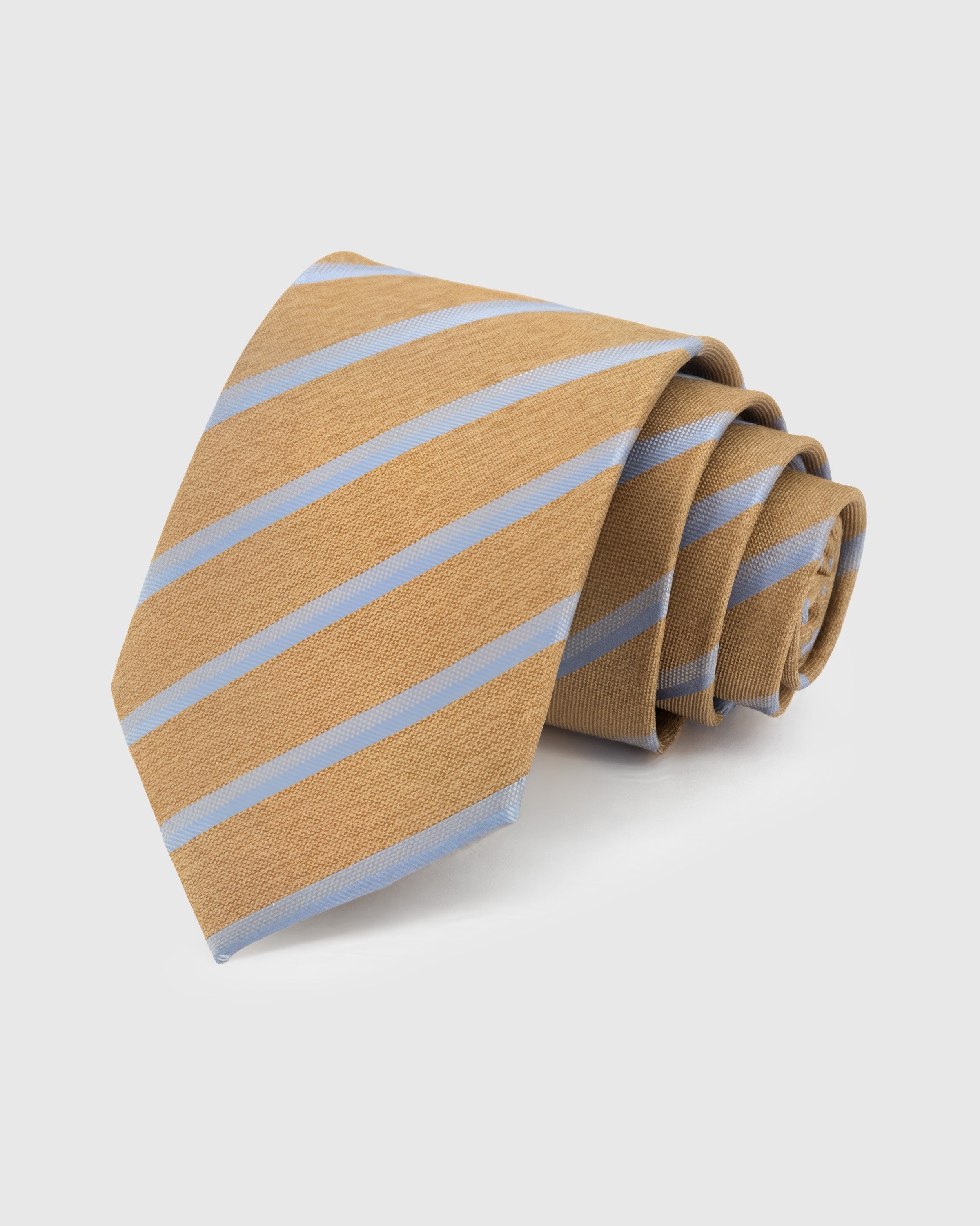 STICKYZOO Camel Sky Stripe Tie in hand-embroidered mulberry silk with sky blue diagonal stripes on warm tan textured ground, 45° bias-cut