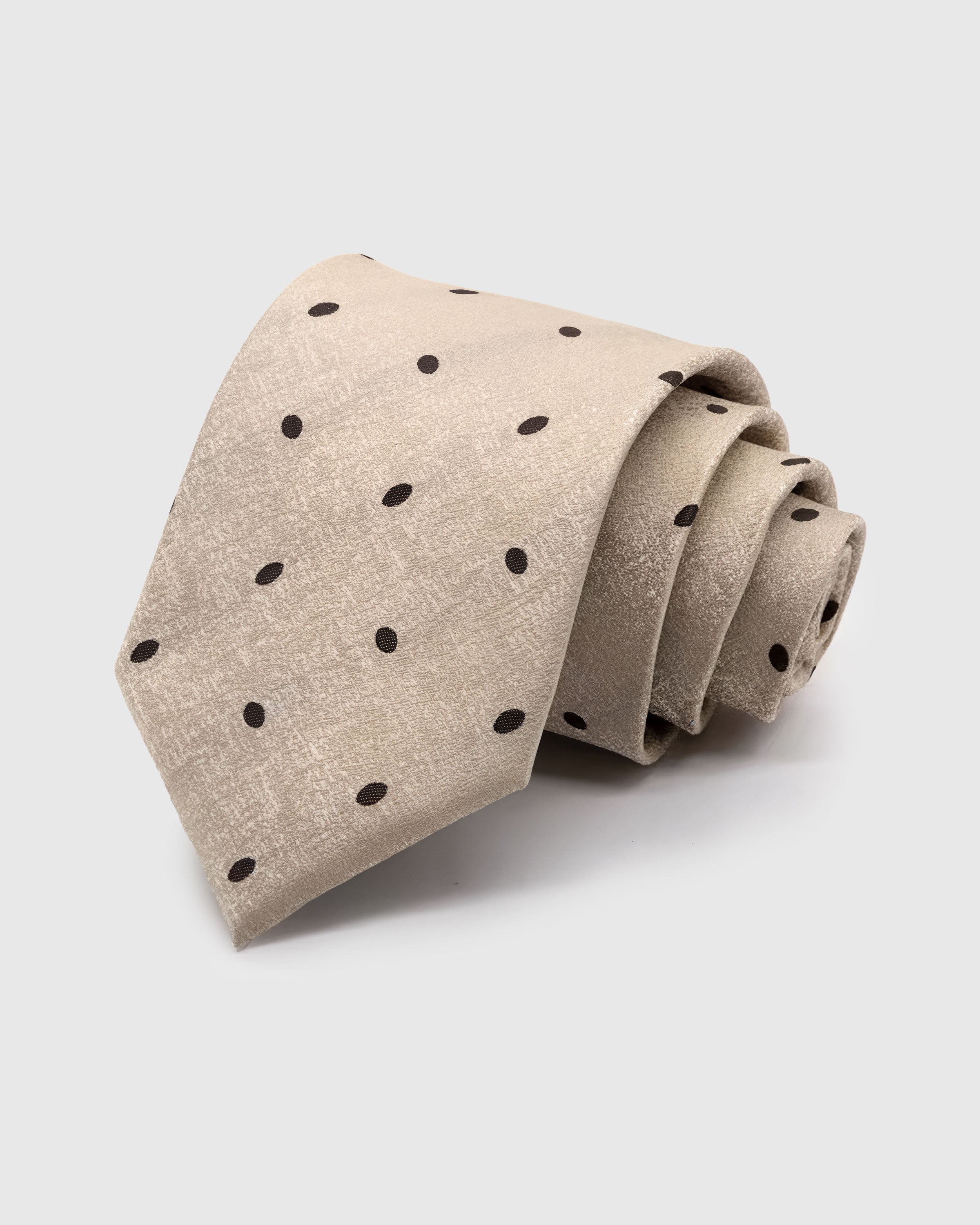 CHAMPAGNE POLKA TIE — Hand-embroidered polka dot detail on 100% mulberry silk in champagne, showing embroidery texture and silk sheen