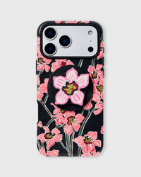 Black phone case with hand-illustrated pink orchid print and built-in MagSafe grip by STICKYZOO