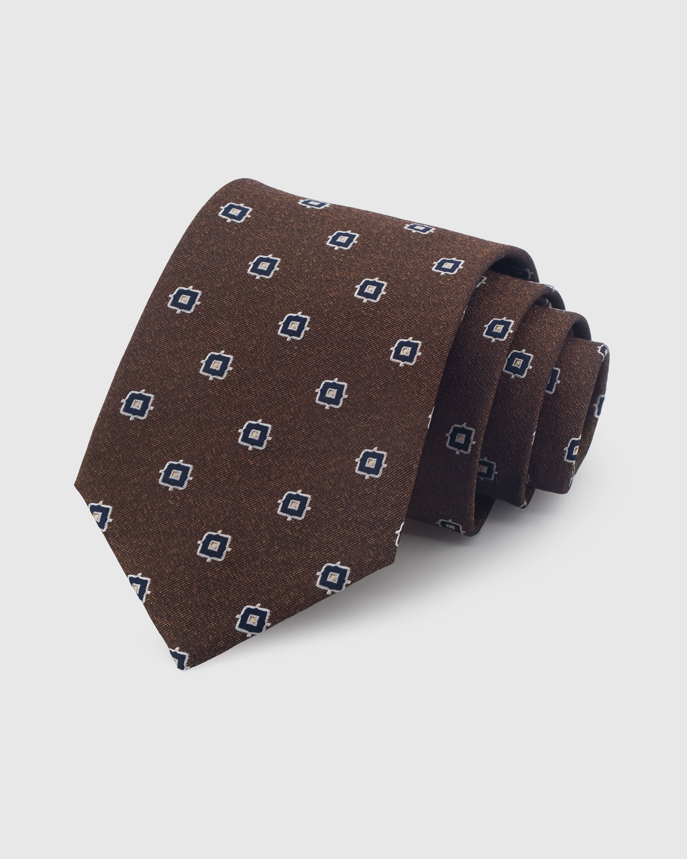 {100% mulberry silk textured weave} STICKYZOO UMBER NAVY FOULARD TIE in hand-embroidered mulberry silk with square foulard motif, 45° bias-cut Italian method
