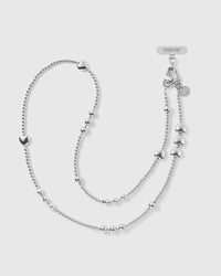 STICKYZOO silver-tone cross-body phone strap laid full length, a ball-bead chain with graduated clusters, puffy hearts, dual clasps and engraved disc.