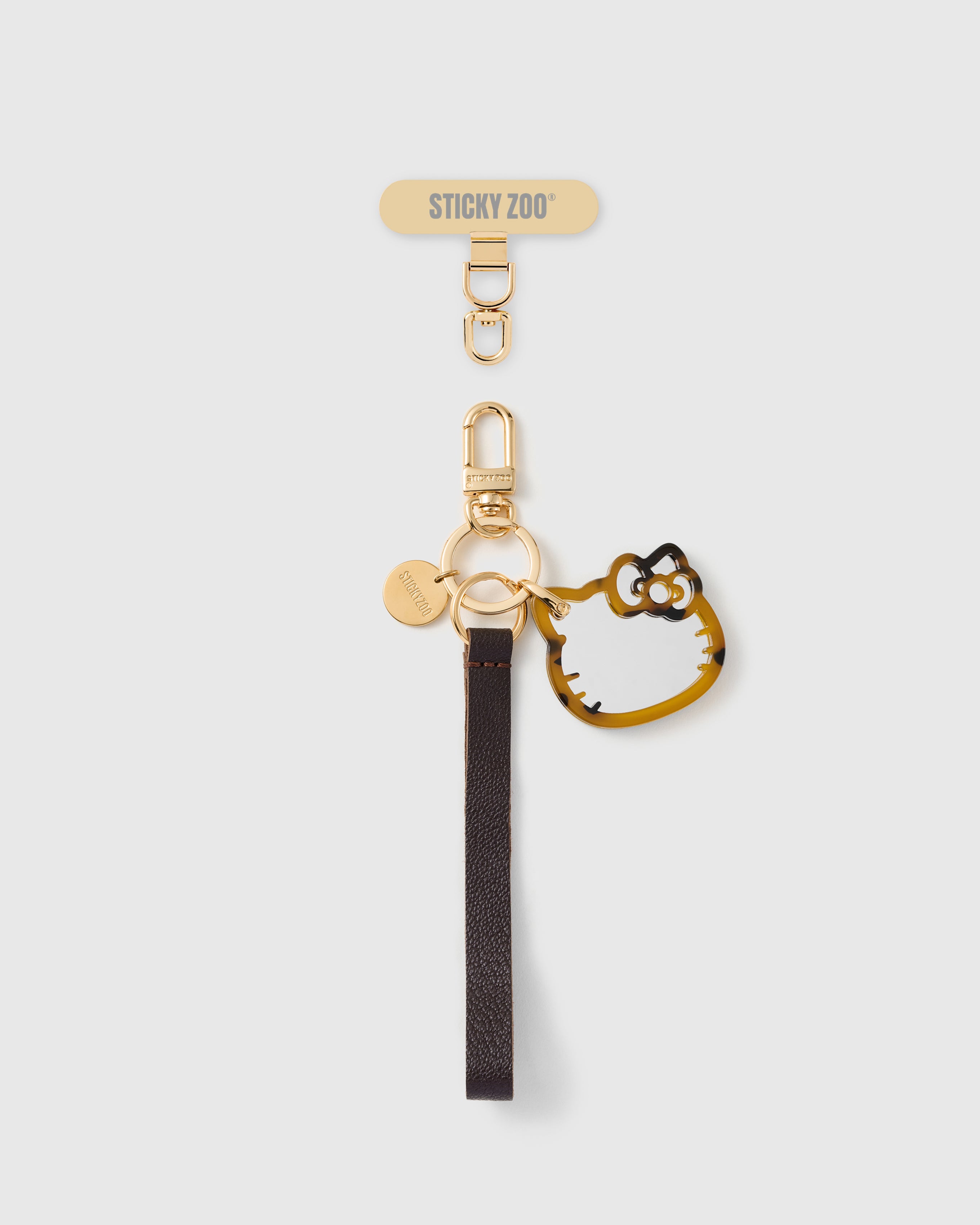 Handmade French Alran cocoa brown leather phone strap with tortoise acetate cat-silhouette mirror charm and 18K gold STICKYZOO hardware
