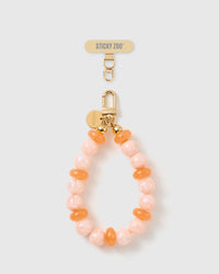 Handmade peach pearl beaded phone strap by STICKYZOO with 18K gold-plated engraved hardware