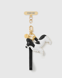 STICKYZOO noir patch pup leather phone strap, hand-stitched black-and-white leather dog charm on a black strap