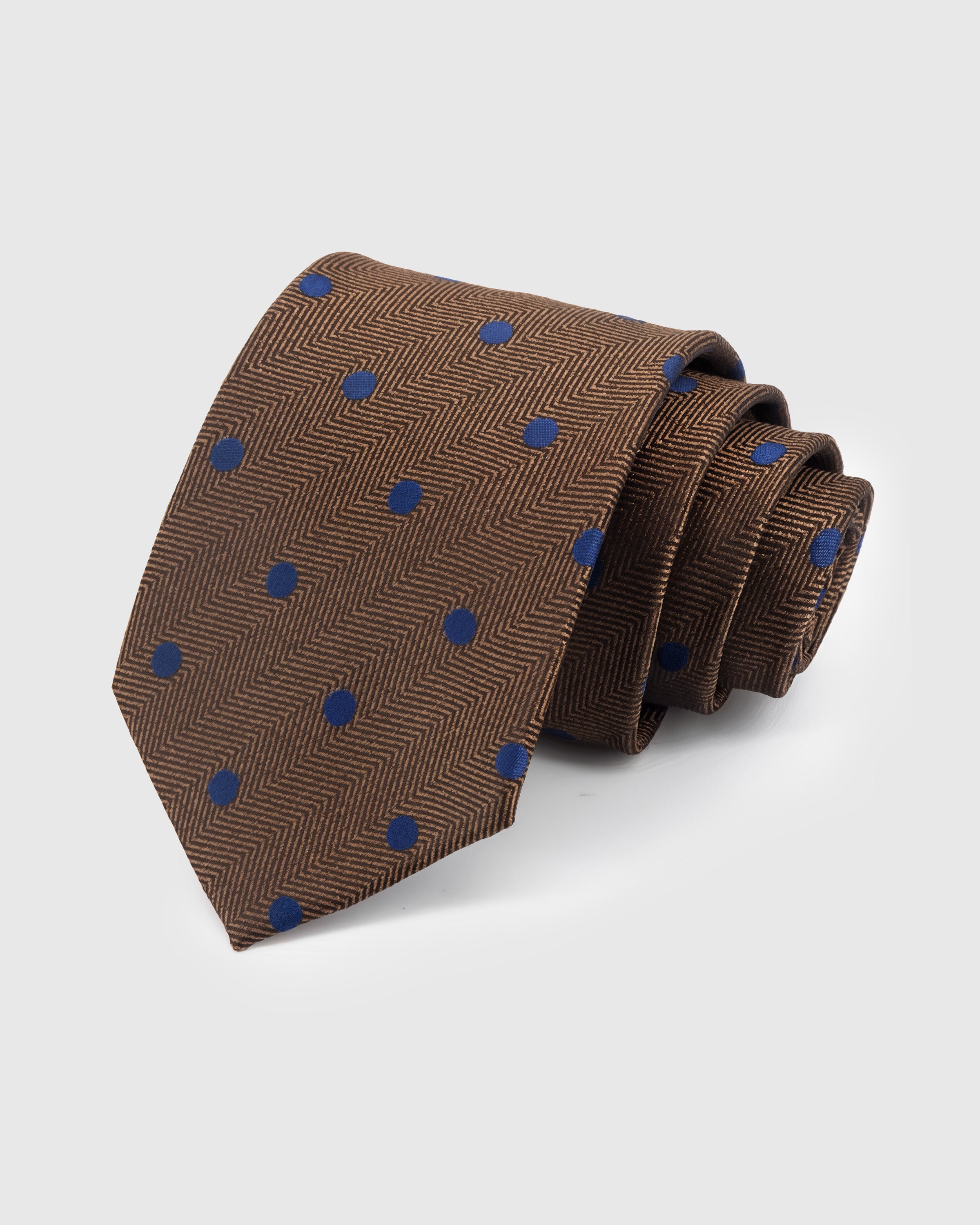 WALNUT POLKA TIE — Hand-embroidered polka dot detail on 100% mulberry silk in walnut, showing embroidery texture and silk sheen