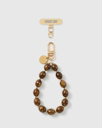 Handmade amber swirl beaded phone strap by STICKYZOO with 18K gold-plated engraved hardware