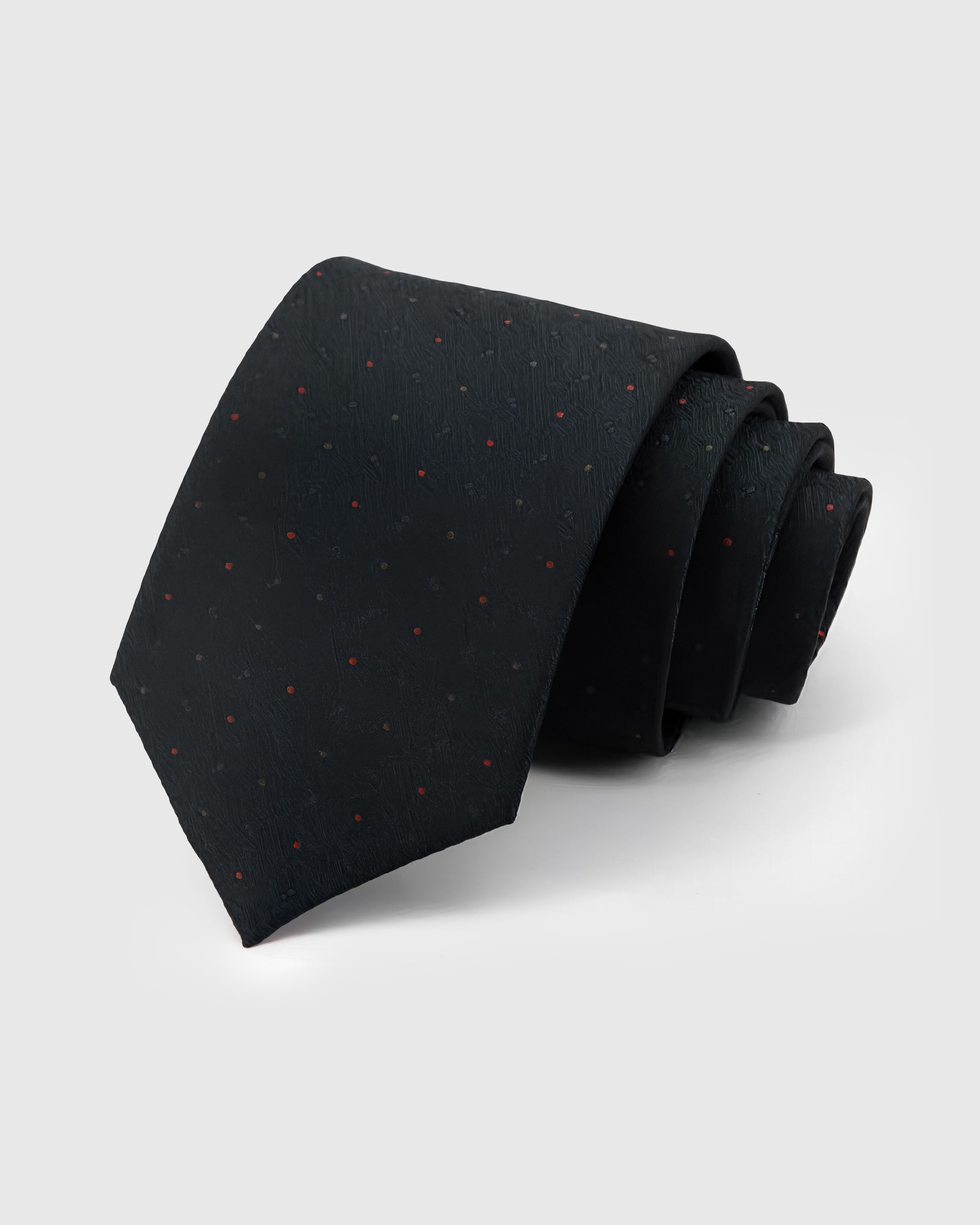 STICKYZOO Obsidian Speckle Tie in hand-embroidered mulberry silk with crimson and gold dots on obsidian textured ground, 45° bias-cut Italian method