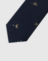 Embroidered, not printed STICKYZOO Golfer Tie flat blade detail showing repeating golfer motifs in tan thread on navy silk