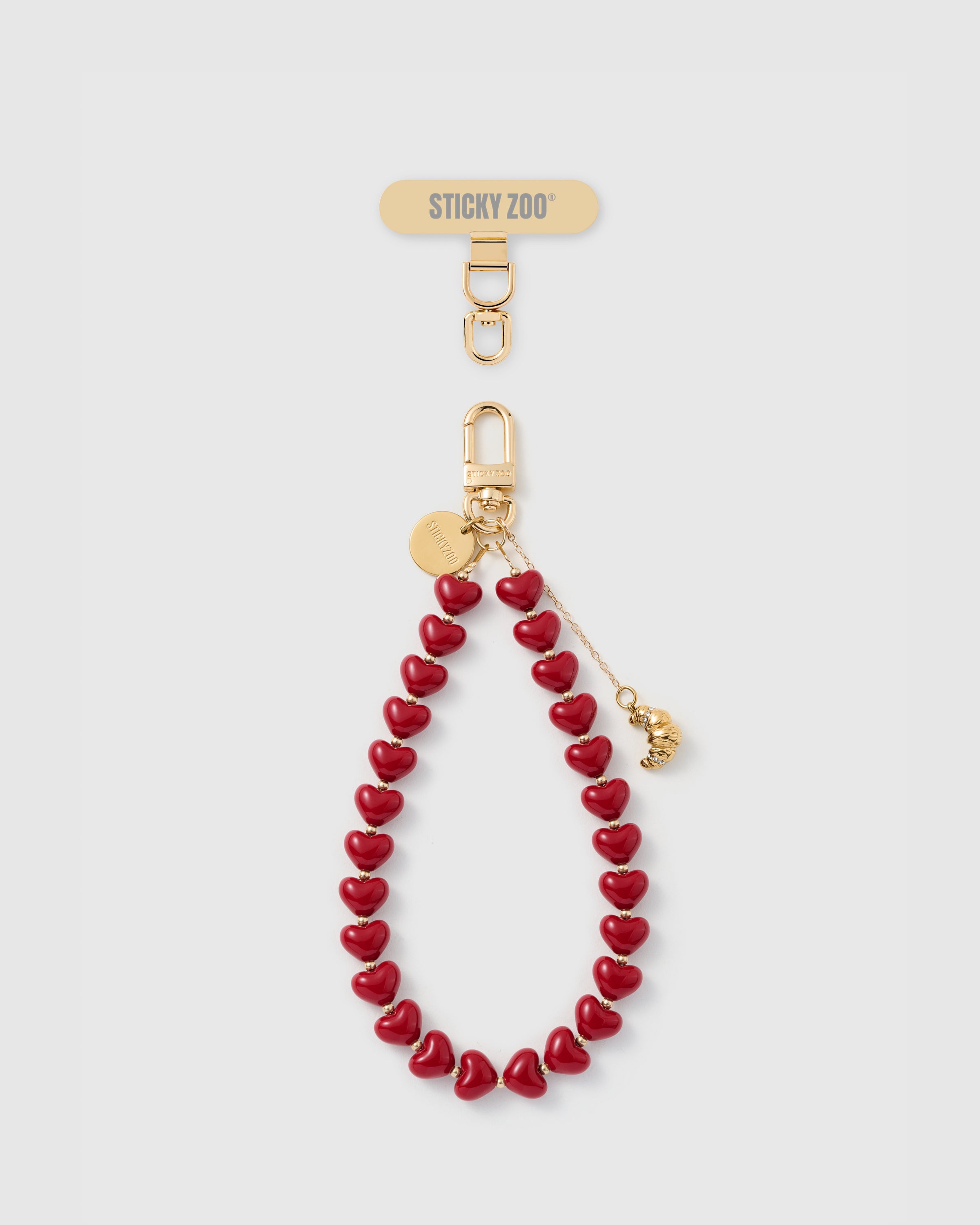 Handmade cherry heart bead phone strap with ridged gold croissant charm and engraved STICKYZOO disc — Rated 4.9 stars