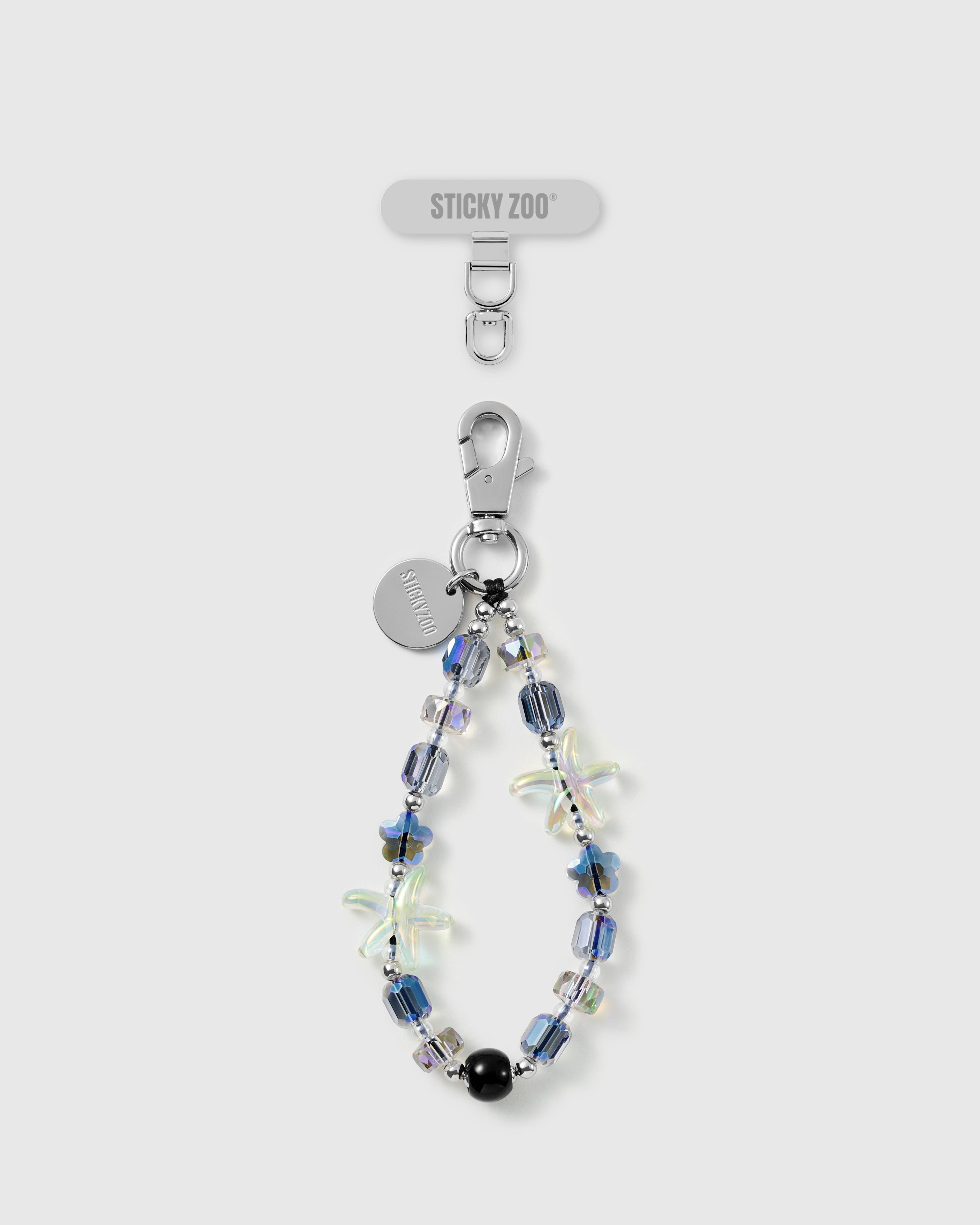 STICKYZOO Aurora Starfish phone strap laid flat: iridescent aurora and faceted blue beads, two jelly starfish, a black bead, and a silver clasp and disc
