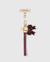 Handmade French Alran wine leather phone strap with dark cocoa enamel bow charm and 18K gold STICKYZOO hardware