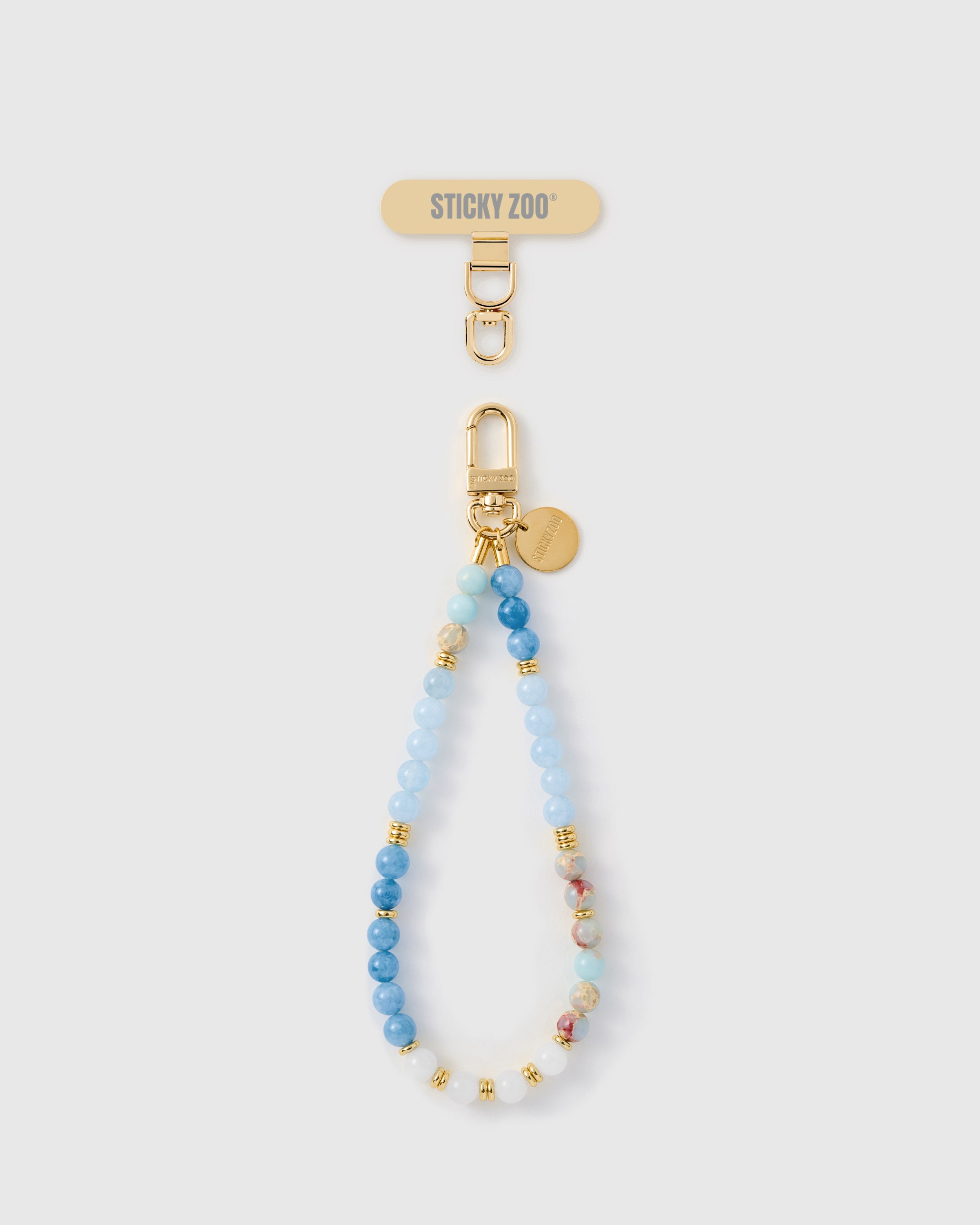 Handmade blue marble-textured stone phone strap with gold-plated engraved hardware by STICKYZOO