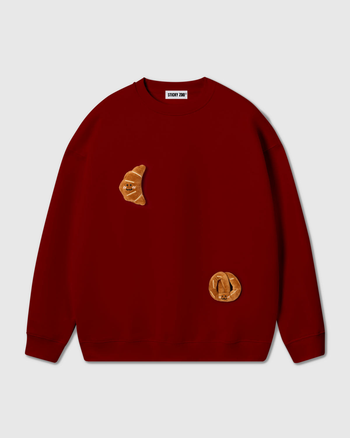 {{2 plush croissants in red}} STICKYZOO DOUBLE CROISSANT SWEATSHIRT in red featuring 2 hand-stitched plush croissants, designed in Amsterdam