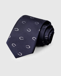 100% mulberry silk STICKYZOO Midnight Horseshoe Tie in navy with hand-embroidered silver horseshoe motifs, rolled to show silk sheen