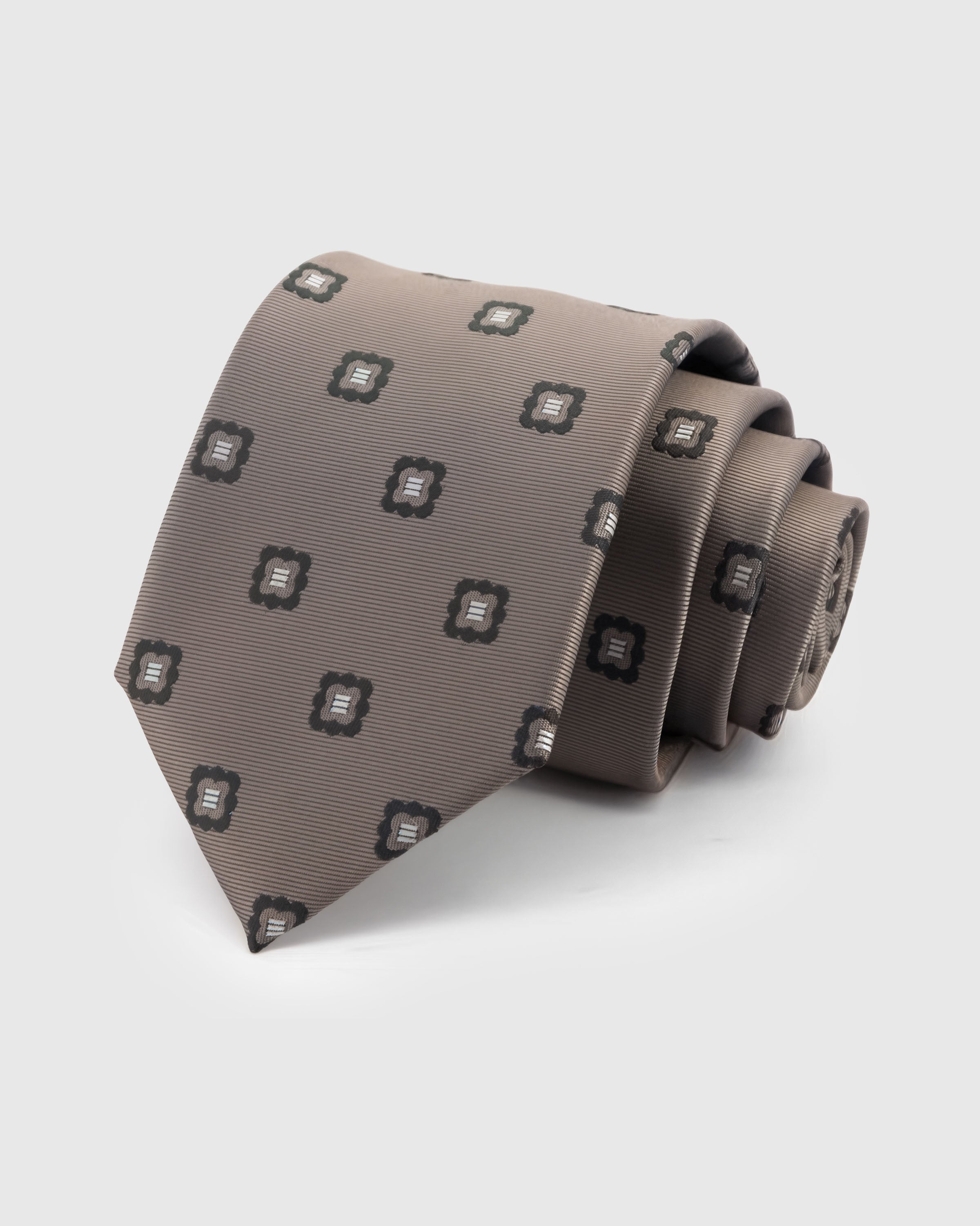 STICKYZOO Taupe Crest Tie — hand-embroidered taupe mulberry silk with spaced crest motif pattern