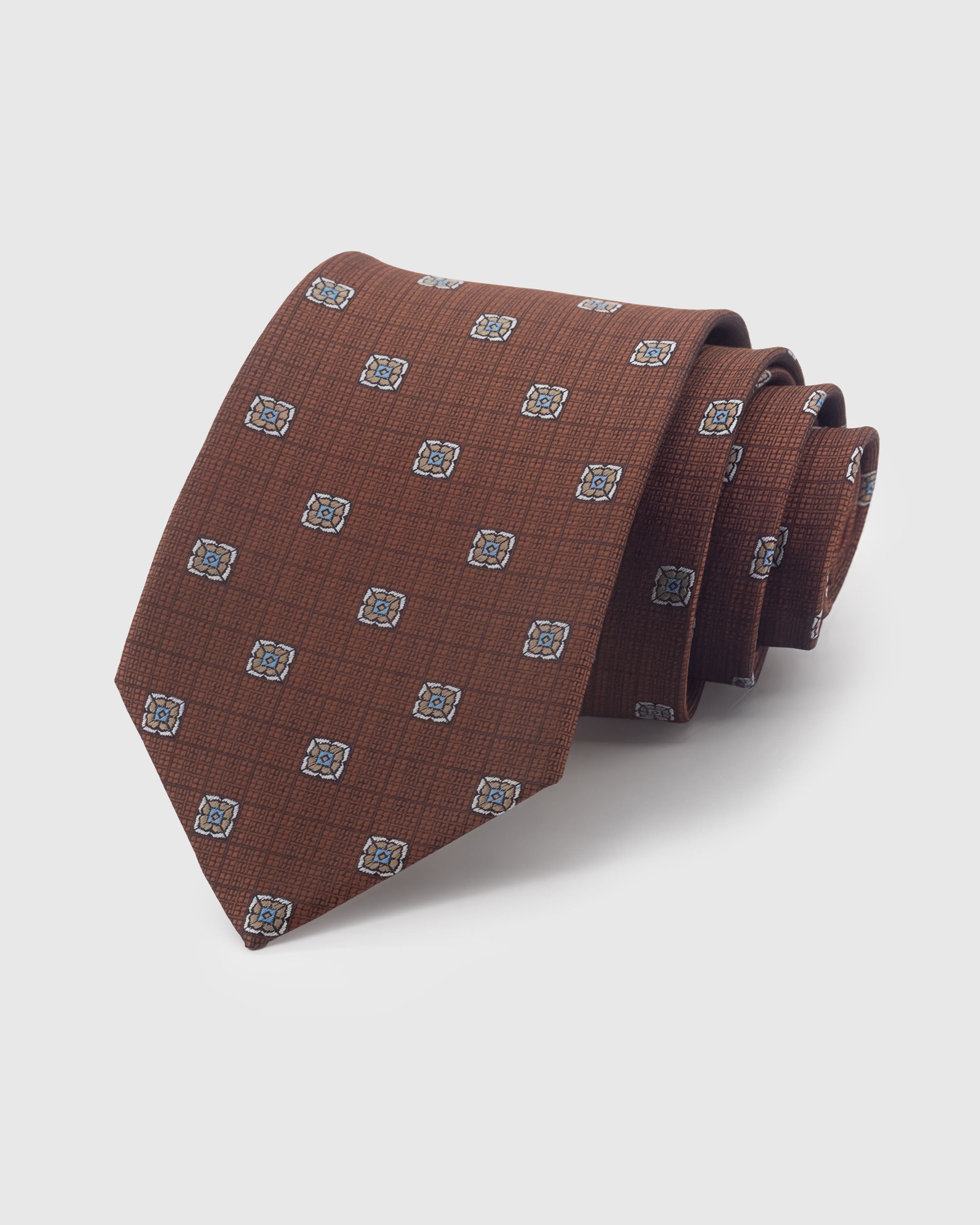 {100% mulberry silk textured weave} STICKYZOO SIENNA MEDALLION DOT TIE in hand-embroidered mulberry silk with medallion dot motif, 45° bias-cut Italian method