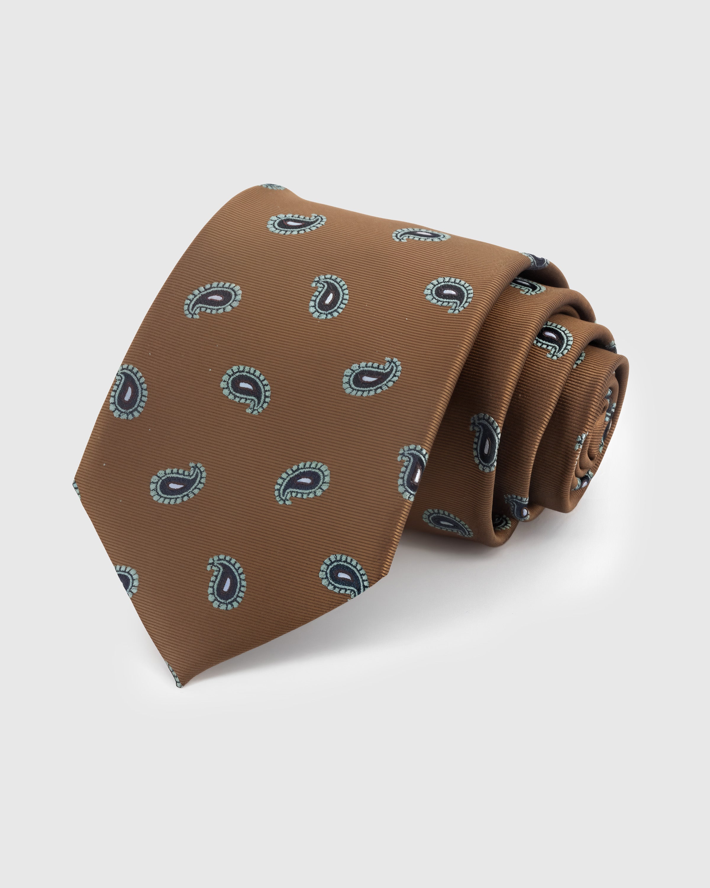 CARAMEL PAISLEY TIE — Hand-embroidered paisley detail on 100% mulberry silk in caramel, showing embroidery texture and silk sheen