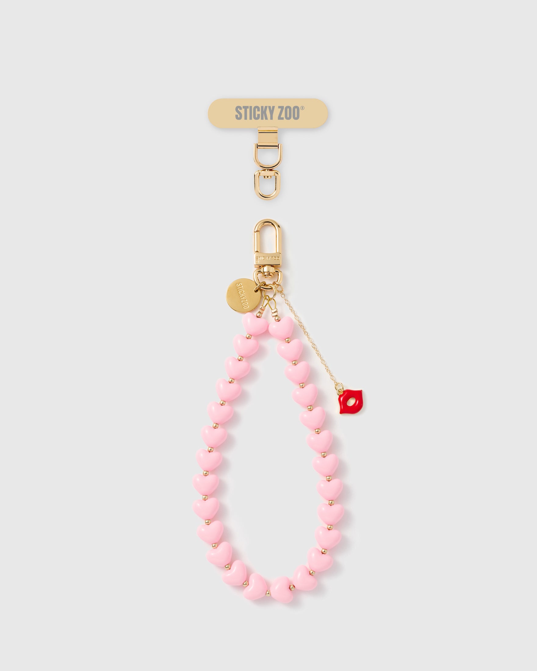 Handmade bubblegum pink heart bead phone strap with red enamel kiss charm and 18K gold hardware engraved STICKYZOO