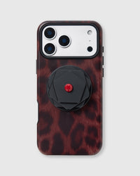 Deep red leopard print phone case with black geometric iris grip medallion and built-in MagSafe stand by STICKYZOO