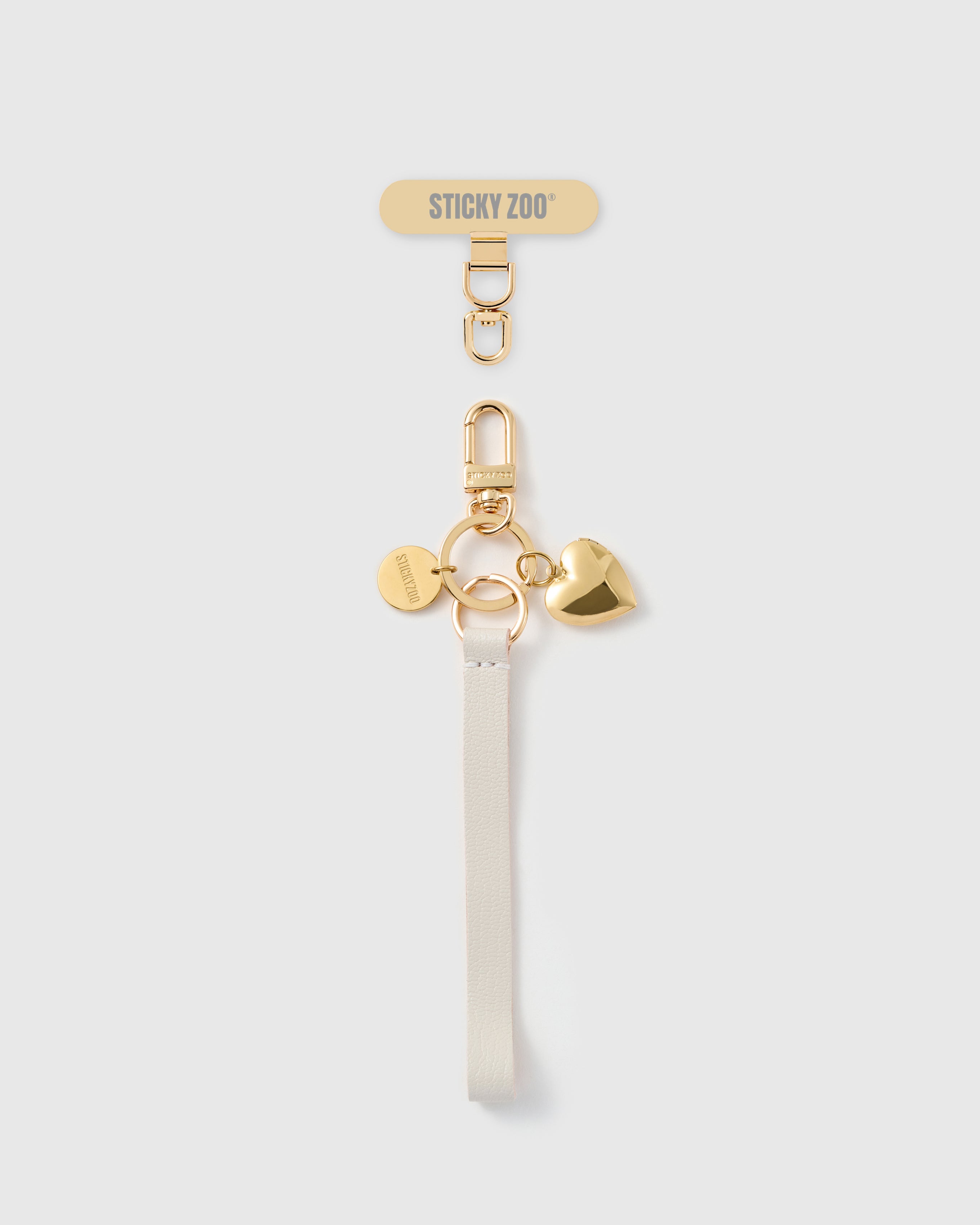 STICKYZOO golden heart leather phone strap — ivory Alran strap, gold-plated puffed heart charm and hardware