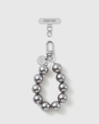 Handmade grey pearl-style beaded phone strap by STICKYZOO with silver-tone engraved hardware