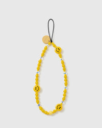 STICKYZOO Sunshine Smiley phone strap laid flat, a full loop of glossy yellow beads with three smiley-face beads, faceted clear accents and gold disc.