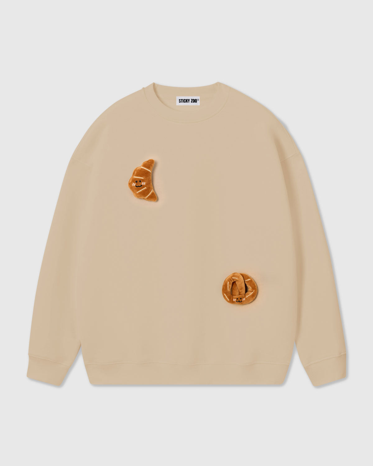 {{Machine wash safe}} STICKYZOO Double Croissant Sweatshirt in cream with warm tonal plush croissant appliques