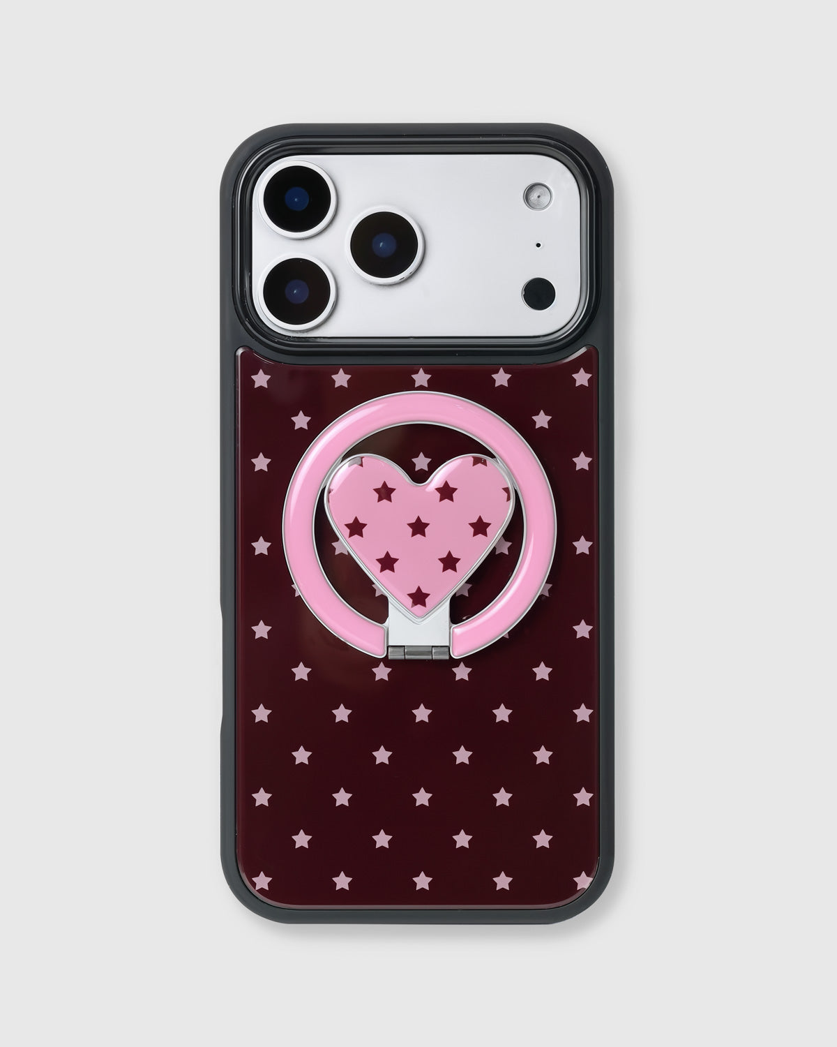 Burgundy phone case with pink stars and a pink heart-in-ring MagSafe kickstand by STICKYZOO