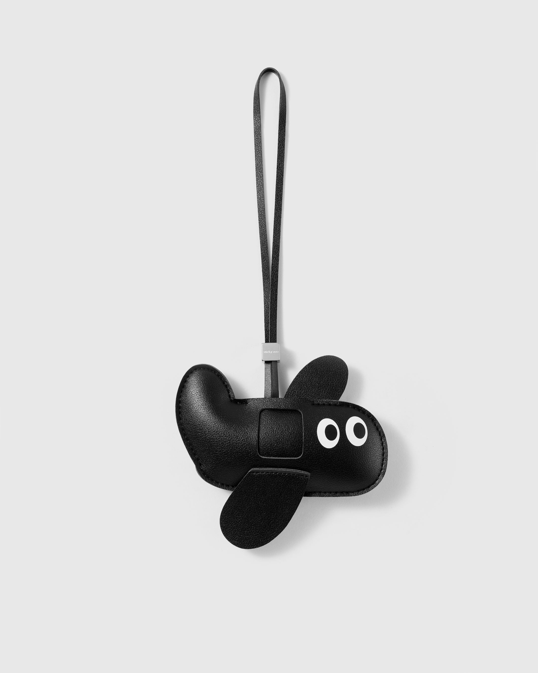 Handmade black French Alran leather puppy bag charm with engraved 18K gold-plated hardware by STICKYZOO