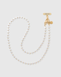 STICKYZOO cross-body phone strap laid full length: white faux-pearls with gold-tone spacer beads and a gold dual clasp with engraved Phone Strap Card.