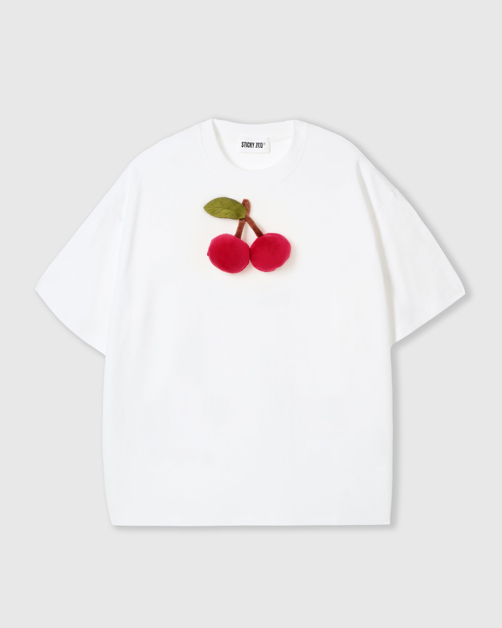 STICKYZOO Cherry T-Shirt in white with a hand-stitched 3D plush cherry pair and stitched green felt leaf