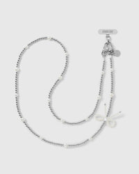 STICKYZOO cross-body phone strap in silver-tone ball beads with faux-pearls and a faux-pearl bow, dual clasps and engraved disc at top.
