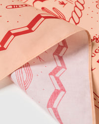 Close-up of the zigzag border meeting the printed peach field on pure silk