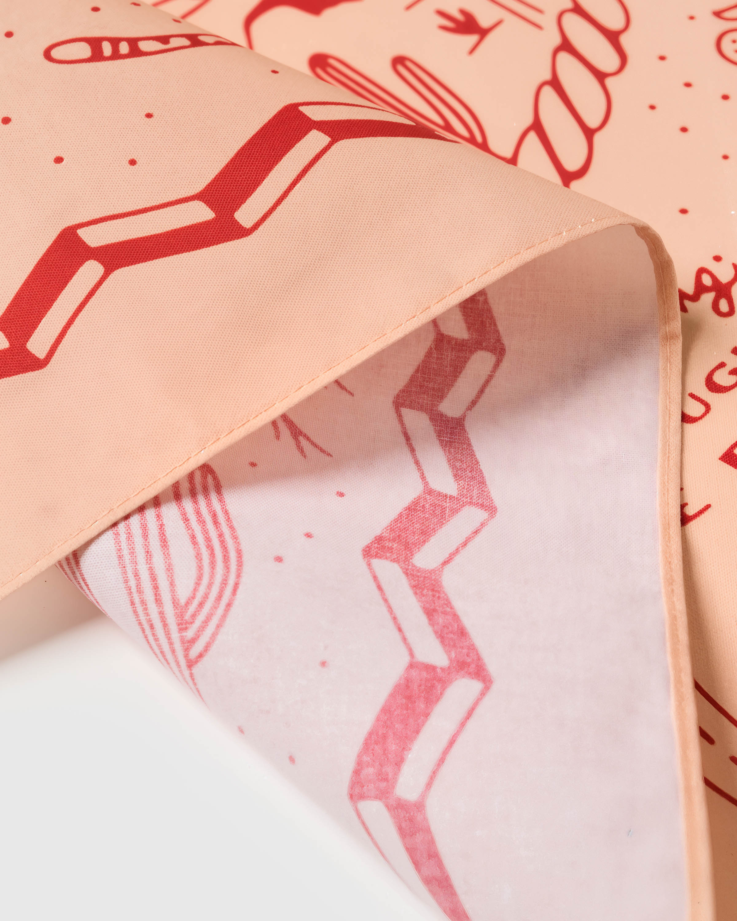 Close-up of the zigzag border meeting the printed peach field on pure silk
