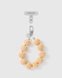 베이지색 복슬복슬한 휴대전화 줄