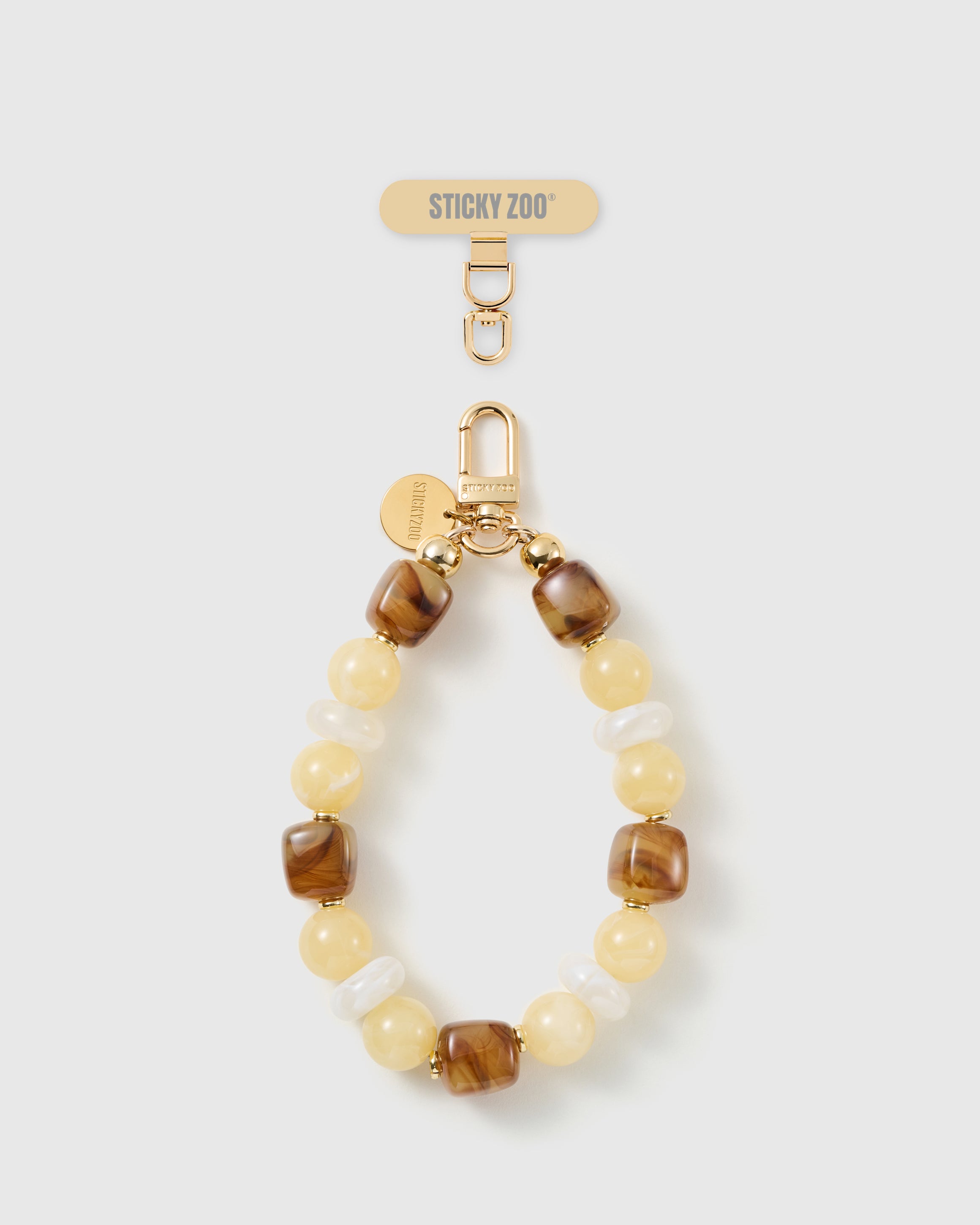 Handmade honey marbled bead phone strap by STICKYZOO with 18K gold-plated engraved hardware