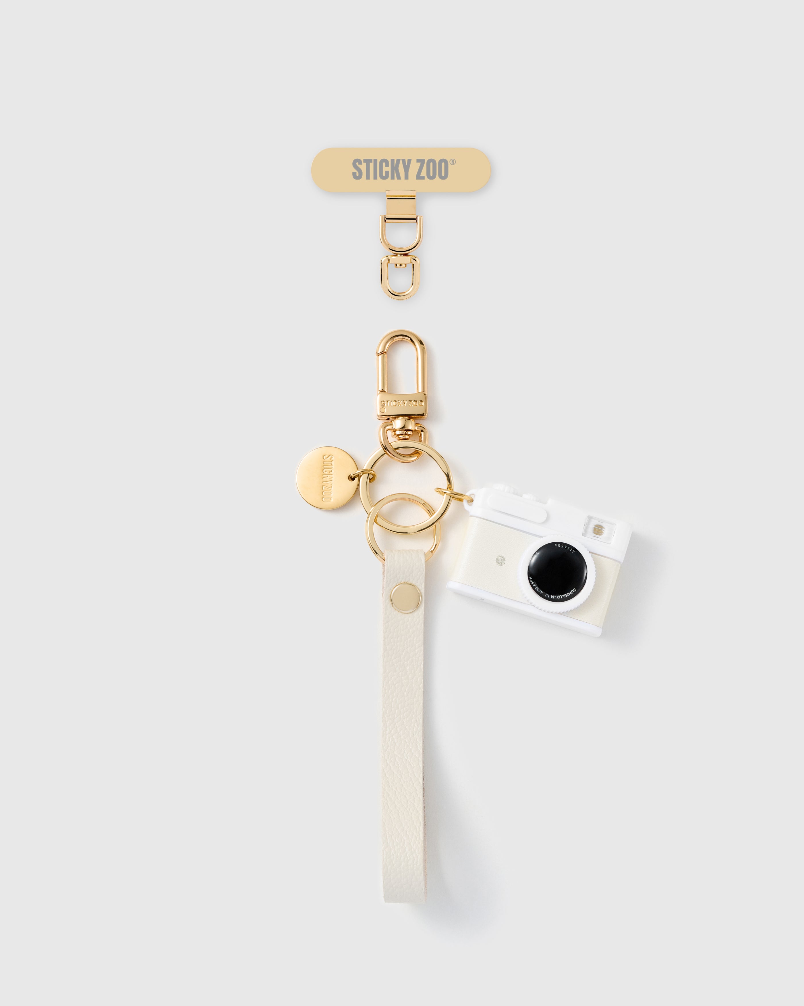 Handmade French Alran cream leather phone strap with ivory mini camera charm and 18K gold STICKYZOO hardware